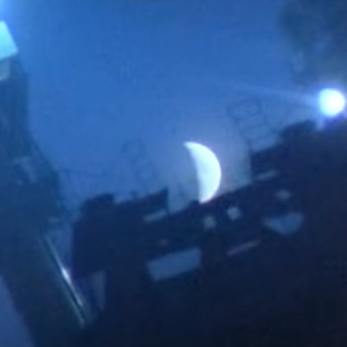 talkradio City Of Corridors cover artwork: Buildings and city infrastructure, blurred and dark against a slightly brighter blue sky. A sickle moon, blurred a bit too, center of the pic. talkradio City Of Corridors cover artwork: Buildings and city infrastructure, blurred and dark against a slightly brighter blue sky. A sickle moon, blurred a bit too, center of the pic.